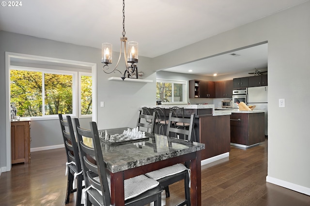 dining room featuring a chandelier and dark hardwood / wood-style floors