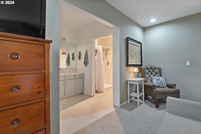 bathroom with a shower with shower curtain, vanity, and tile patterned floors