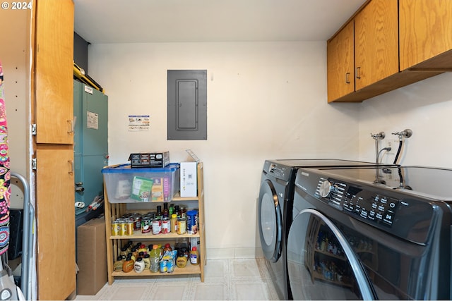 laundry area with electric panel, cabinets, and washer and dryer