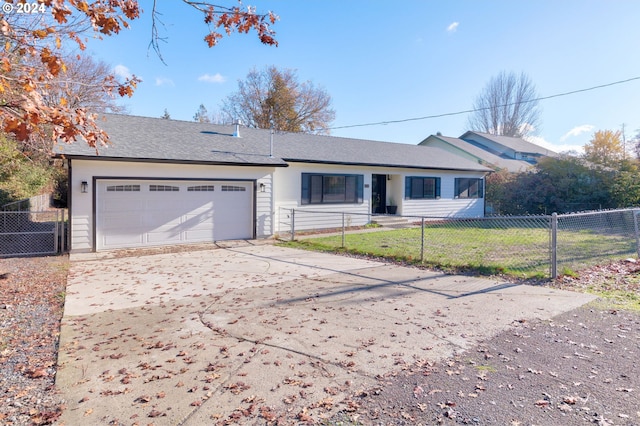 single story home with driveway, an attached garage, fence, and a front yard