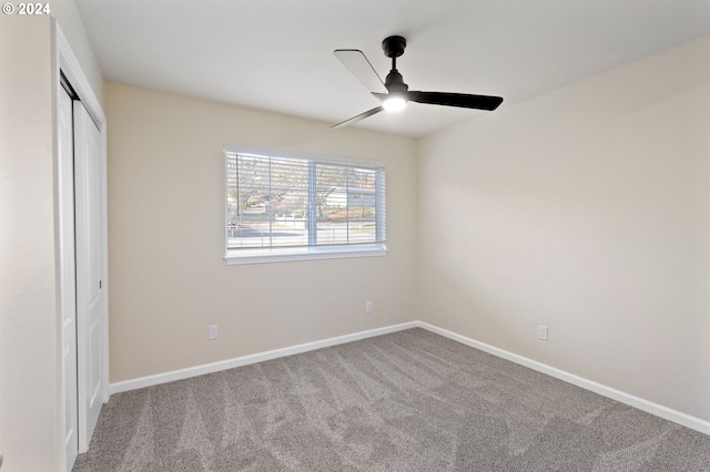 unfurnished bedroom featuring ceiling fan, a closet, and carpet floors