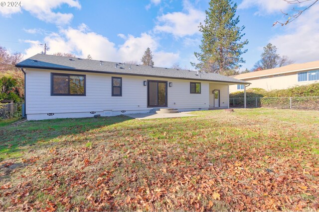 rear view of house with a patio area and a yard