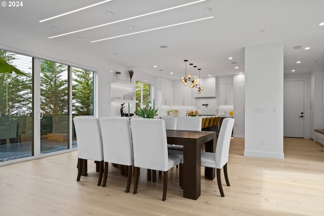 dining room featuring a notable chandelier and light hardwood / wood-style floors