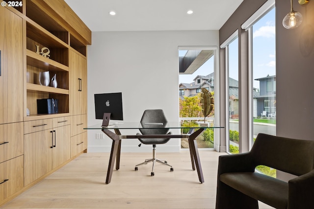 office area with light hardwood / wood-style floors