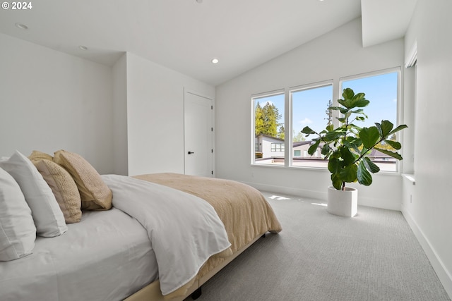 carpeted bedroom featuring lofted ceiling