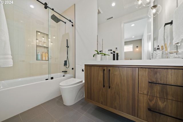 full bathroom featuring tile patterned flooring, vanity, toilet, and bath / shower combo with glass door