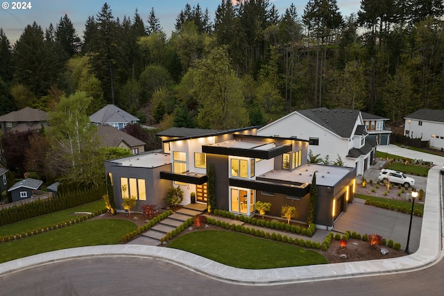 modern home with a garage and a lawn