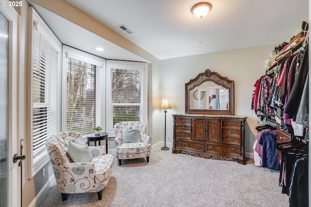 sitting room featuring light carpet