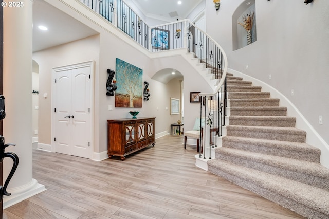 foyer featuring light hardwood / wood-style floors and a high ceiling