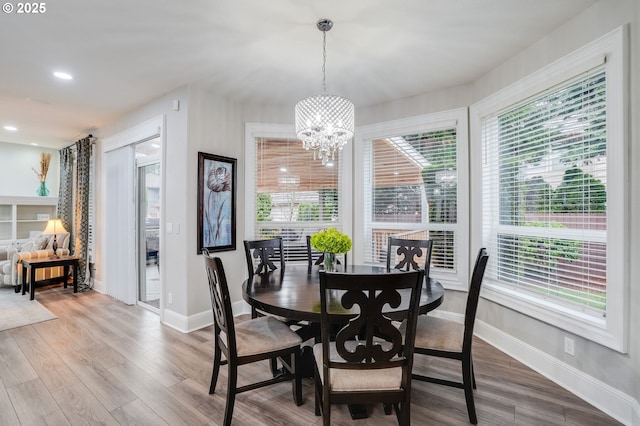 dining room featuring wood-type flooring and a chandelier