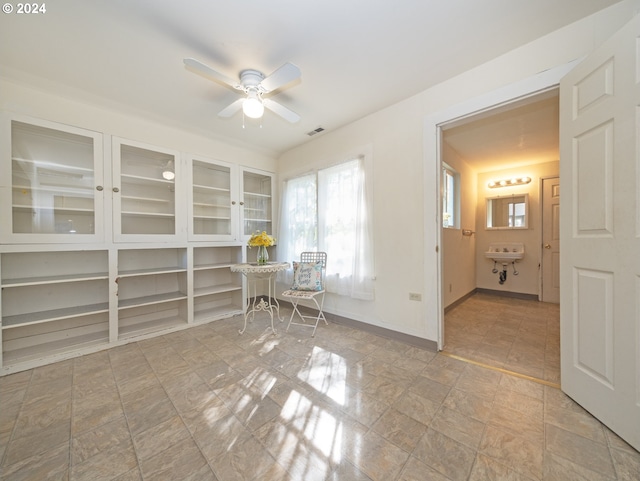 interior space with ensuite bath and ceiling fan