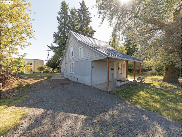 view of property exterior featuring a porch and a yard