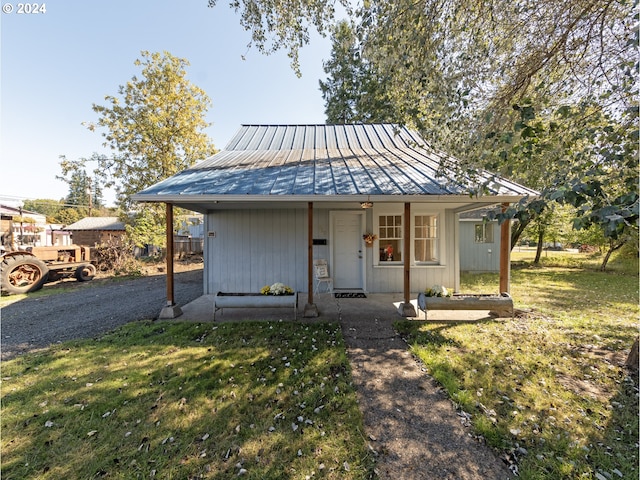 bungalow-style home with a porch and a front yard