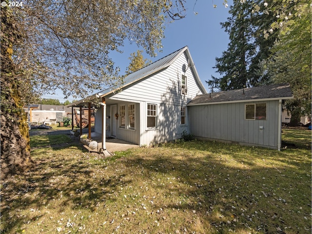 back of property featuring a yard and a patio