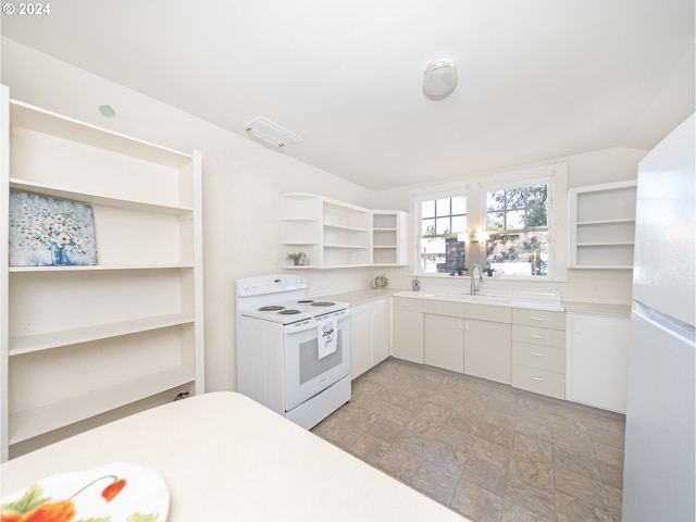 kitchen featuring white appliances, white cabinetry, and sink