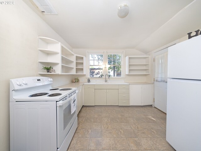 kitchen with white appliances, vaulted ceiling, and sink