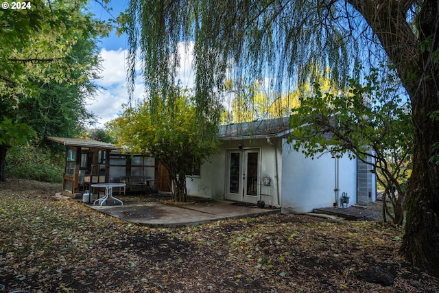 rear view of property with french doors and a patio area