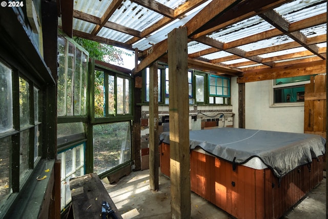 sunroom featuring a hot tub