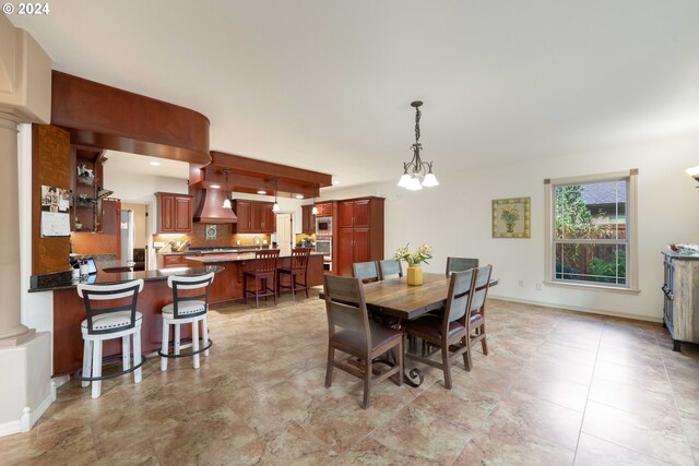 dining area with tile patterned floors and a notable chandelier