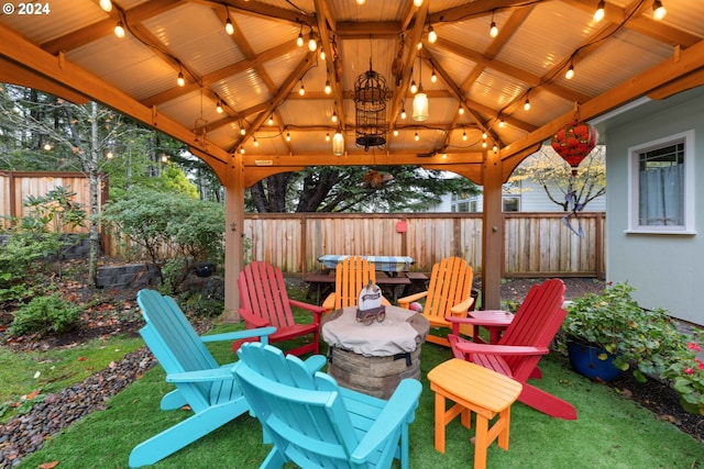 view of patio featuring a gazebo and a fire pit