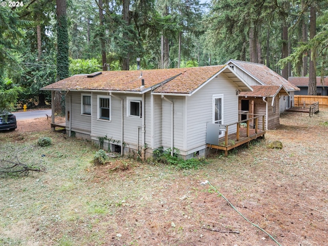 rear view of property with a wooden deck