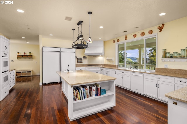 kitchen with white cabinets, dark hardwood / wood-style floors, white appliances, and premium range hood