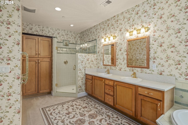 bathroom with tile patterned flooring, shower with separate bathtub, vanity, and a textured ceiling