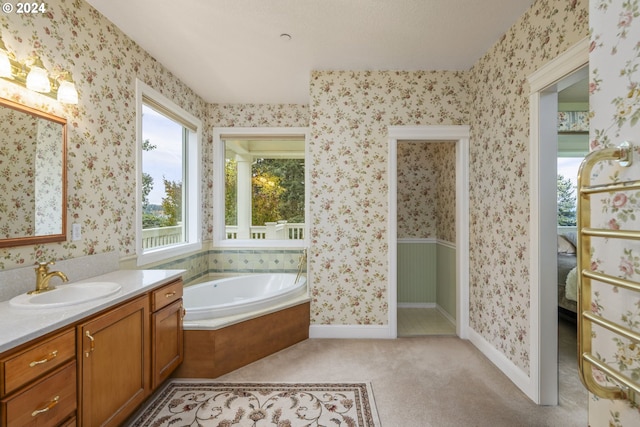 bathroom with vanity and a bath