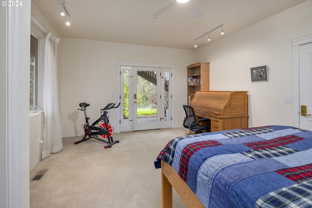 carpeted bedroom featuring access to exterior, track lighting, and ceiling fan