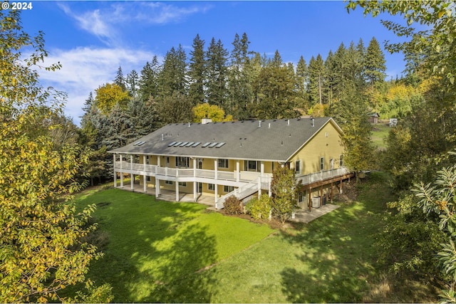 back of house with a lawn, a patio, and a deck