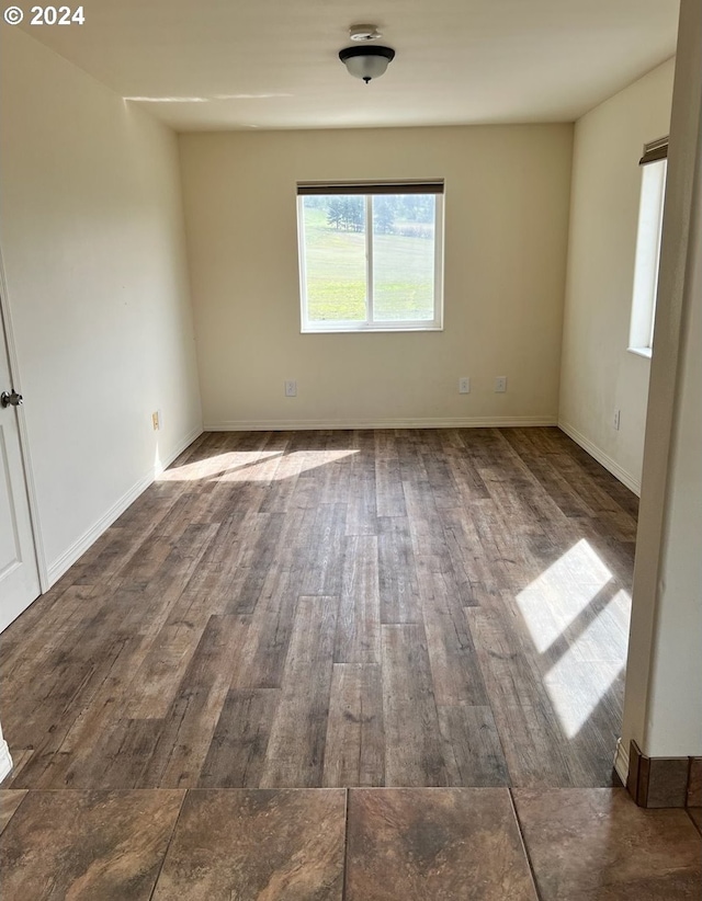 empty room featuring dark wood-type flooring