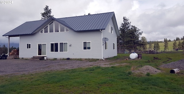 rear view of property with a yard