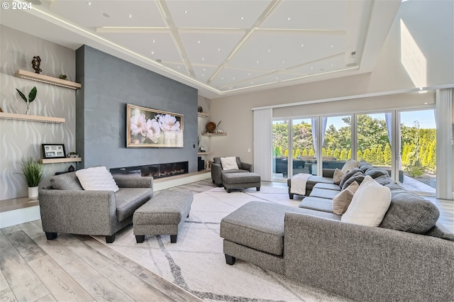 living room featuring a large fireplace and light hardwood / wood-style floors