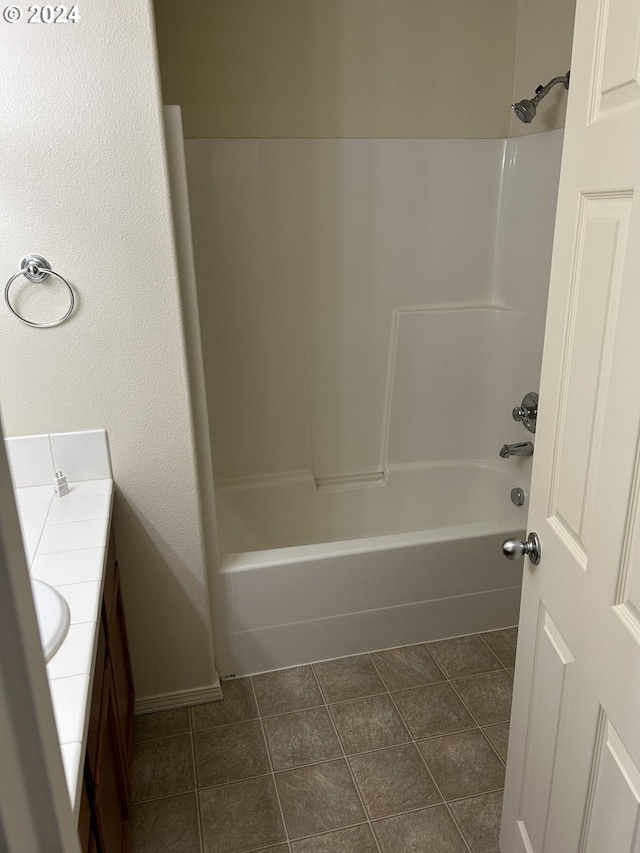 bathroom with tile patterned floors, shower / washtub combination, and vanity