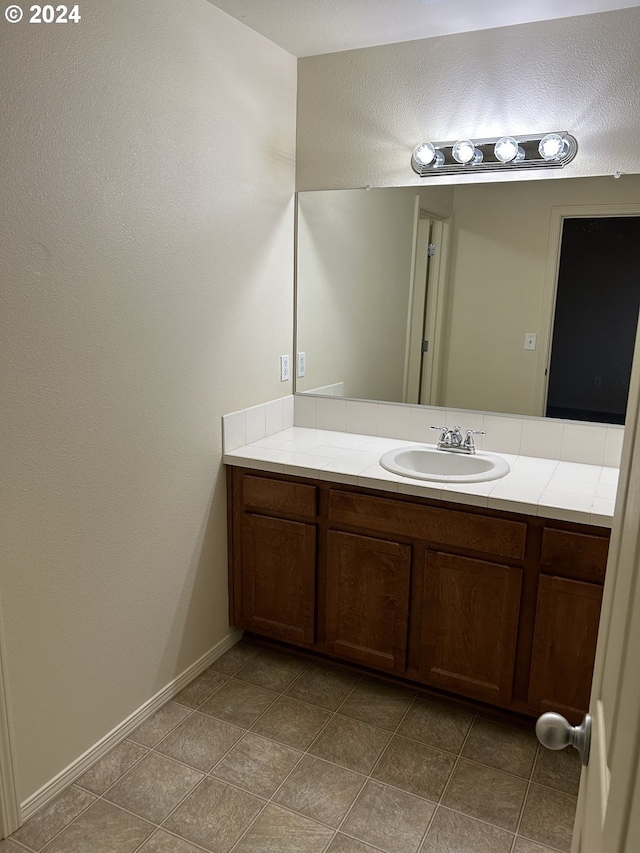 bathroom with tile patterned flooring and vanity