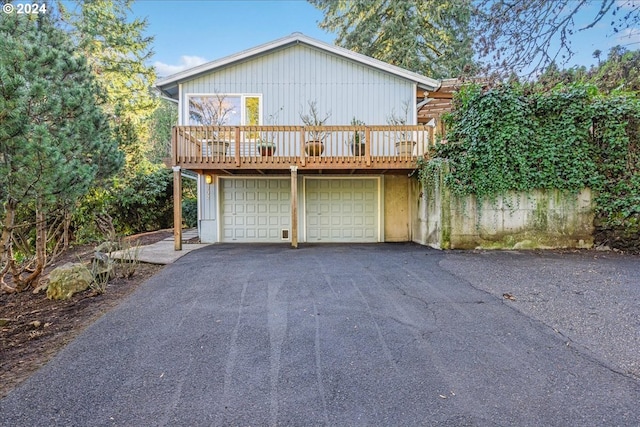 view of property featuring a garage and a deck