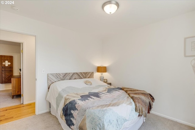 bedroom featuring light colored carpet