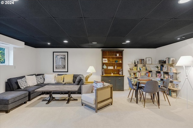 carpeted living room with a drop ceiling