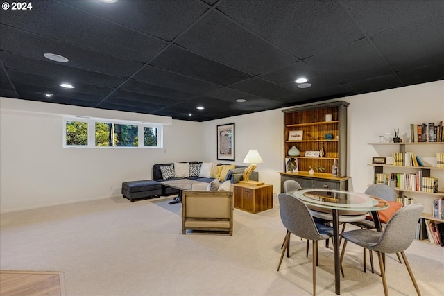 carpeted living room with a paneled ceiling