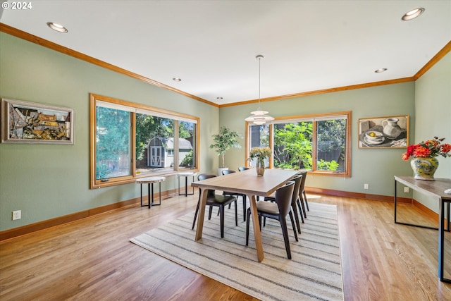 dining area with crown molding, plenty of natural light, and light hardwood / wood-style floors