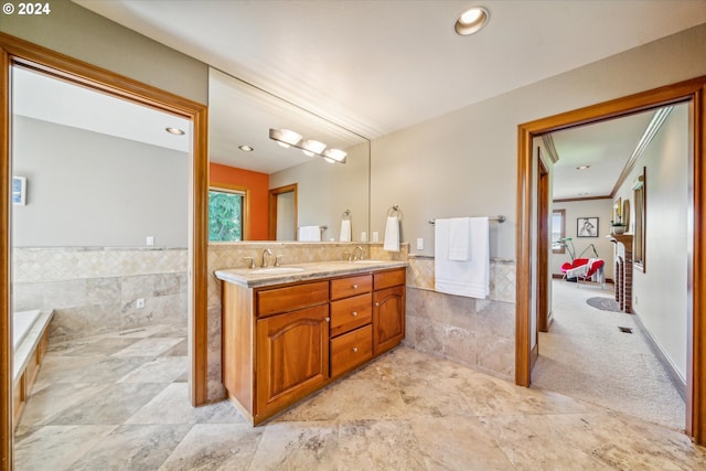 bathroom with vanity, ornamental molding, and tile walls