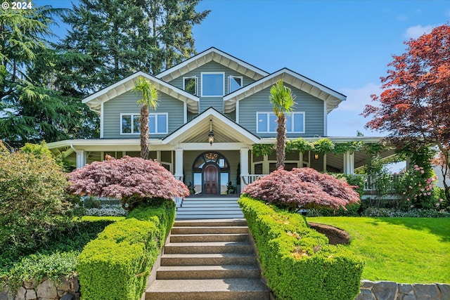 craftsman inspired home with covered porch and a front lawn