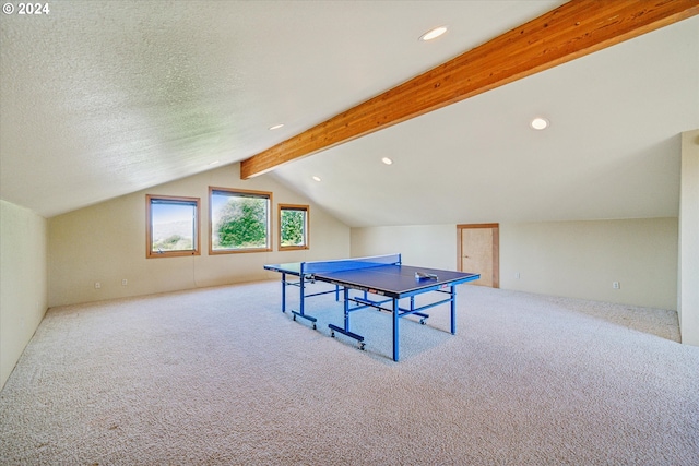 rec room featuring a textured ceiling, vaulted ceiling with beams, and light carpet