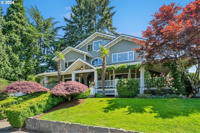 craftsman house with covered porch and a front yard