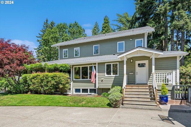 view of front of house featuring a front yard and a porch