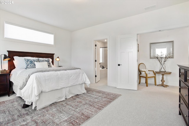 carpeted bedroom featuring ensuite bathroom