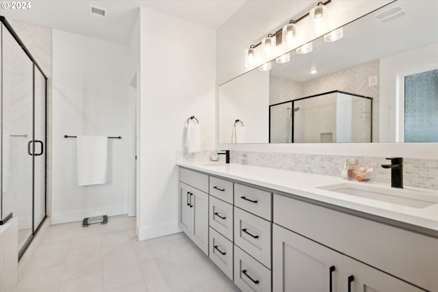 bathroom with vanity, decorative backsplash, walk in shower, and tile patterned flooring