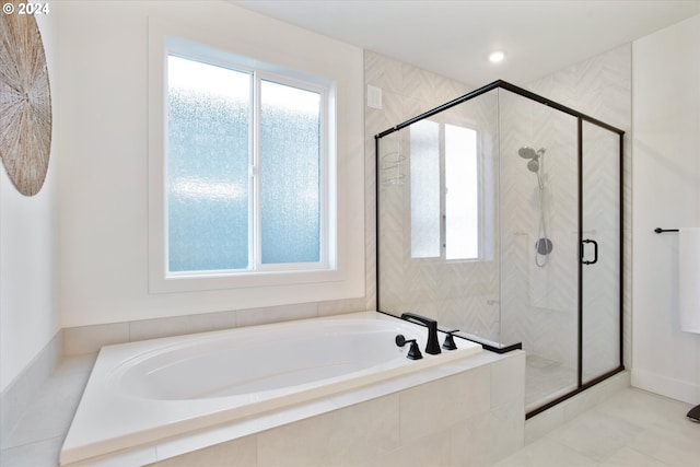 bathroom featuring tile patterned flooring, a healthy amount of sunlight, and separate shower and tub