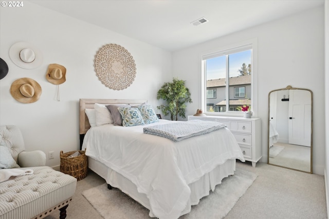 bedroom featuring light colored carpet