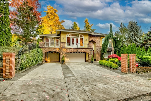 bi-level home featuring a balcony and a garage